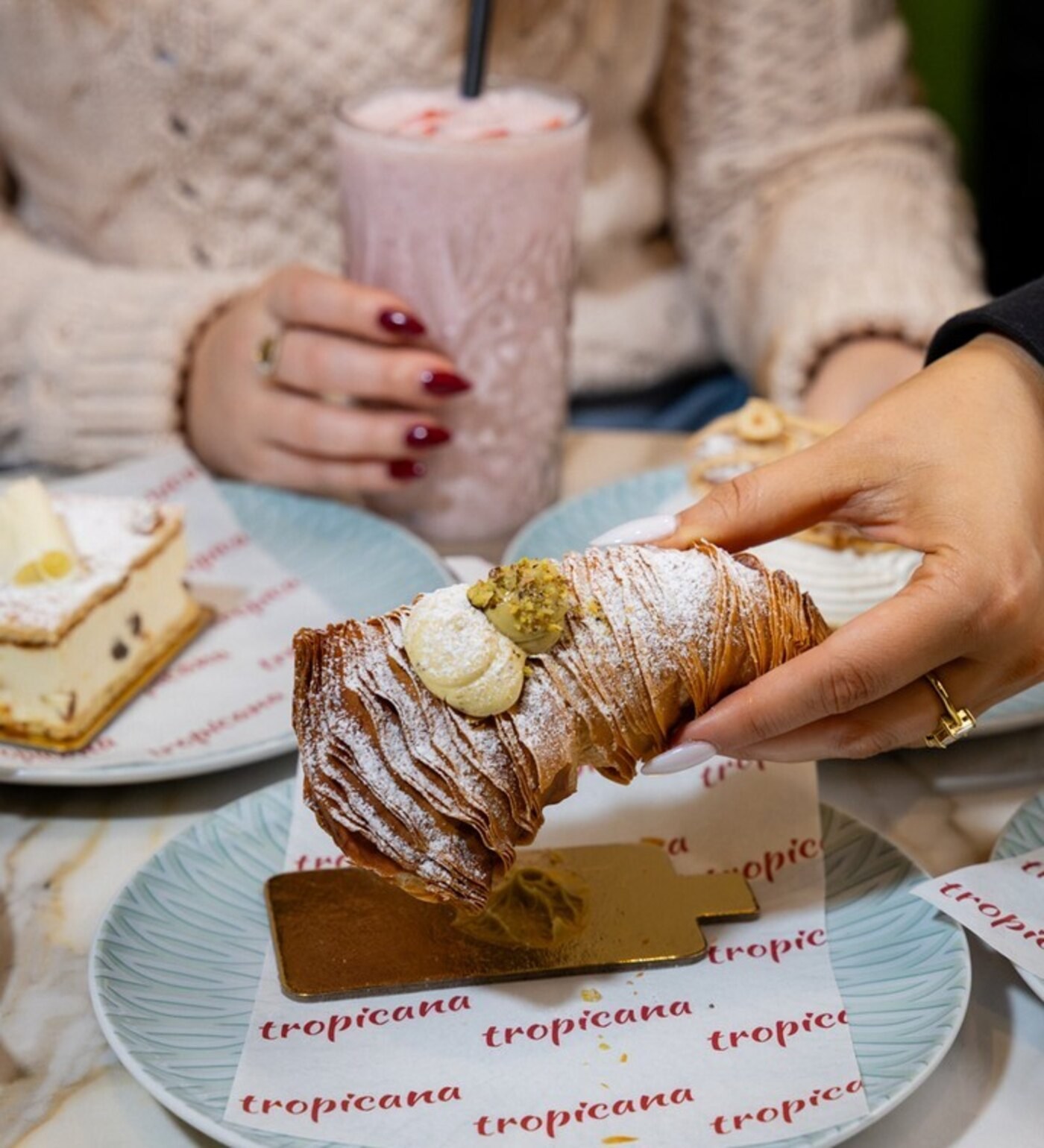 Hand holding a cornetto pastry